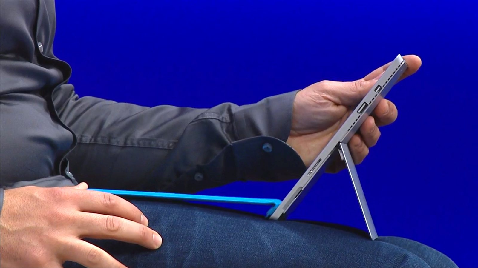 Panos Panay clicks the keyboard cover onto the front of the Surface Pro 3 to increase stability.